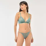 Conjunto de lencería compuesto por un corpiño triangular y una tanga, confeccionados en tul transparente color azul con estampado de pequeñas flores. El corpiño cuenta con breteles finos y un pequeño lazo decorativo en el centro.