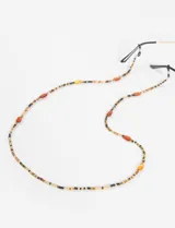 Correa para lentes con diseño de cuentas acrílicas en tonos marrones, negros y dorados, con terminales de goma ajustable.