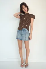 Falda pantalón de tiro medio confeccionada en denim, con bolsillos delanteros y cierre frontal con cremallera y botón metálico.