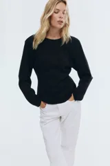 Top de manga larga negro, confeccionado en tejido con textura efecto neopreno. Presenta escote redondo al frente y escote en V pronunciado en la espalda. El calce es entallado en la cintura con un bajo levemente acampanado.