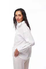 Camisa blanca de algodón con cuello clásico, manga larga y bolsillo en el pecho.
