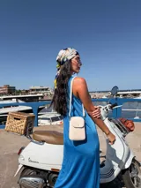 Bandolera pequeña tipo porta celular, color verde claro, confeccionada en cuero sintético. Cuenta con cierre principal, bolsillo frontal con tapa y broche a presión, y correa ajustable extraíble.