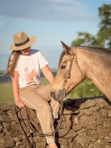 Remera blanca de manga corta y cuello redondo con diseño estampado en el frente de siluetas de caballos.