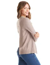 Cardigan de tejido liviano en color beige, con frente abierto y solapas tipo cascada. Presenta mangas largas entalladas con puños de rib y detalle de botones en la espalda.