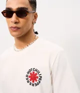 Remera de algodón blanca, de corte levemente suelto, con cuello redondo, mangas cortas y estampa en la espalda de Red Hot Chili Peppers con una rosa roja al centro.