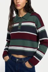 Sweater de punto con diseño a rayas horizontales en tonos verde, bordó, azul marino y gris. Presenta cuello tipo polo con cierre frontal de tres botones, mangas largas y corte cropped.