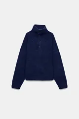 Jersey de punto de color azul marino con cuello perkins y cierre frontal con botones. Presenta un diseño de manga larga con hombros caídos y textura suave.
