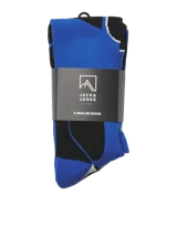 Medias deportivas extra largas de diseño técnico, color beige con estampado geométrico en azul. Presentan refuerzos en la zona del pie con franjas negras y detalle de marca en la puntera.