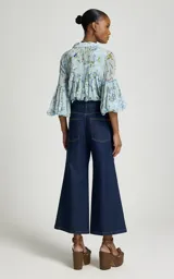 Jean flare corto de tiro alto, color azul oscuro, con cierre de botones y bolsillos delanteros.