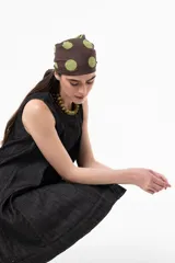 Vestido corto sin mangas de denim negro, con silueta evasé, calce suelto y costuras pespunteadas a contratono.
