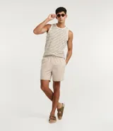 Bermuda de baño tipo boardshort color beige, confeccionada en microfibra con cintura elástica, cordón ajustable y bolsillos laterales.