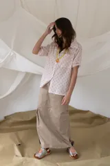 Camisa rosada con estampado de anclas y rayas sutiles, de manga corta, cuello clásico y cierre frontal de botones.