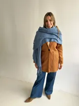Abrigo estilo sastrero de textura tipo bouclé en color camel, con cierre frontal de un botón, solapas clásicas y bolsillos frontales tipo plaqué.