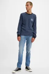 Jean de hombre marca Levi's modelo 501 Slim Taper, color azul medio, de tiro medio y corte slim.