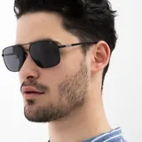 Lentes de sol INVU unisex, con montura metálica negra, forma cuadrada y lentes polarizadas grises.
