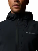 Campera softshell híbrida Columbia Trailborne para hombre, de color negro, con capucha, cierre frontal y bolsillos con cremallera. Cuenta con tecnología Omni-Shield de repelencia al agua y detalles reflectantes.