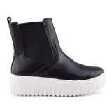 Botín Chelsea negro de cuero sintético con elásticos laterales y plataforma blanca con suela dentada.