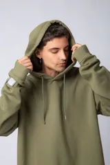 Buzo canguro oversize de tela friza, color negro, con capucha, cordones ajustables con logo y bolsillo frontal tipo canguro.