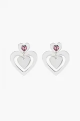 Aros colgantes plateados con forma de corazón doble y cristal rosa en la parte superior.