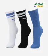 Kit de tres pares de medias deportivas Puma de caña larga. Incluye un par blanco con rayas azules y logo, un par negro con rayas blancas y logo, y un par azul liso. Confeccionadas en tejido de algodón suave y transpirable.