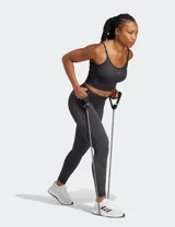 Calza deportiva Adidas Seamless 7/8 de tiro alto, color negro, confeccionada con tejido suave y elástico sin costuras con tecnología AEROREADY. Presenta diseño de líneas acanaladas en la cintura y los tobillos, y las tres tiras características de la marca en el muslo derecho.