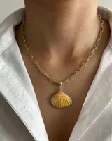 Collar con cadena de eslabones dorados y dije de concha marina natural en tonos amarillos y naranjas.