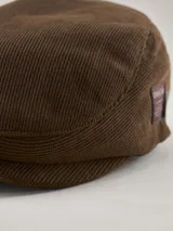 Boina de estilo clásico color negro, confeccionada en tejido de punto acanalado. Presenta una etiqueta rectangular con el logo de la marca Benson & Thomas en el lateral.