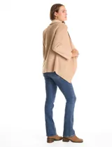 Cardigan de tejido soft color beige con solapa ancha en contraste de tono más claro, diseño abierto y manga larga.