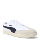 Championes urbanos Puma modelo 9T, con diseño inspirado en el fútbol sala. Presentan una combinación de cuero sintético negro en los laterales y gamuza negra en la puntera, con la icónica franja lateral de Puma en color blanco y suela de goma color caramelo.