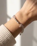 Pulsera de plata italiana 925, compuesta por una cadena de eslabones finos y una sección de esferas metálicas, con un dije colgante en forma de estrella.