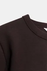 Camiseta de manga larga confeccionada en tejido de punto interlock elástico y flexible, con cuello redondo y bajo recto.