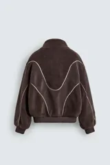 Cazadora de corte relajado confeccionada en tejido de borreguillo con diseño de paneles en tonos marrón y beige. Presenta cuello subido, cierre frontal de cremallera, bolsillos laterales y acabados en rib en puños y cintura.