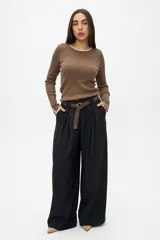 Pantalón de vestir negro de corte wide leg, con diseño de pinzas en la cintura, bolsillos laterales y cierre frontal. Confeccionado en tejido fluido.