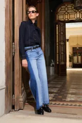 Jean wide leg bicolor con paneles de denim en dos tonos de azul, tiro alto y bajo deshilachado.