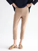 Pantalón capri color beige con detalle de tres botones en el ruedo.