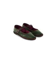 Ballerina tipo Mary Jane de terciopelo verde oscuro, con ribetes y tira con hebilla en tono marrón. Presenta detalle de yute trenzado alrededor de la suela y suela plana de goma.