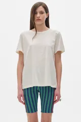 Remera color crudo de algodón lavado, con cuello redondo, manga corta y corte oversized.