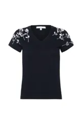 Remera negra de algodón pima, con escote en V, mangas cortas y detalles bordados plateados en los hombros.