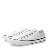 Championes de corte bajo Converse modelo Chuck Taylor All Star, confeccionados en cuero blanco con puntera de goma, cordones al tono y suela de goma vulcanizada con detalle de línea negra.