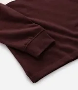 Saco de algodón con diseño de bloques de color en tonos marrón, verde y blanco. Presenta cuello polo con cierre de botones y mangas largas.
