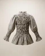 Blusa de algodón color tostado, con cuerpo elastizado tipo nido de abeja, mangas abullonadas con puños fruncidos, cuello alto con volado y dobladillo acampanado.