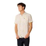 Camisa de manga corta Rip Curl modelo Vaporcool Sessions Aerotech, color blanco con estampado tropical de palmeras en tonos amarillos y rosados. Cuenta con cuello camisero, cierre frontal de botones y un bolsillo aplicado en el pecho con etiqueta de la marca.