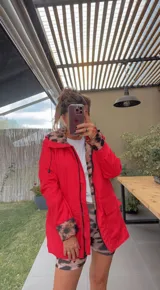 Campera negra con capucha, cierre frontal con cremallera y bolsillos laterales. Interior con forro de animal print.