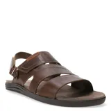 Sandalias de cuero vacuno color marrón habana, con diseño de tiras anchas cruzadas y ajuste mediante velcro en el talón. Presenta detalle de marca grabado en una etiqueta de cuero y suela de goma ergonómica.