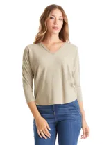 Buzo de tejido fino con escote en V, mangas tres cuartos estilo dolman y corte holgado.