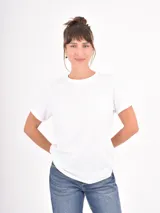 Remera básica de algodón color blanco, con cuello redondo y mangas cortas con dobladillo.