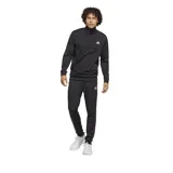 Conjunto deportivo Adidas negro, compuesto por campera con cierre y cuello alto, y pantalón con cintura elástica. Ambos con logo Adidas en blanco.