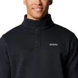 Buzo de forro polar Columbia con cuello alto y cierre frontal parcial con botones a presión. Presenta un diseño liso en color negro con el logo de la marca bordado en el pecho.