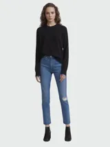 Jean de denim azul claro, corte skinny, largo al tobillo, tiro alto, con rotura en la rodilla y terminación desflecada.