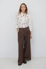 Pantalón de corte ancho y tiro alto, confeccionado en tejido con textura tipo espiga en color azul. Presenta pinzas en la cintura y costuras reforzadas.